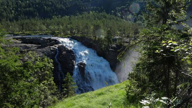 RjukanFossen waterfall, sunny, summer day, in Tinn, Agder, South Norway - pan shot
