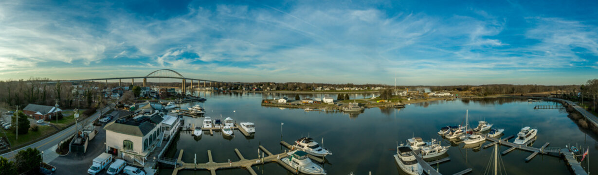 Aerial Panorama Of Chesapeake City Maryland Historic Fishing Town On The Chesapeake Delaware Canal With Private Boats Docked In The Marina And The Chesapeake City Bridge Over The Back Creek