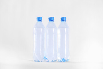 Plastic bottles with pure water on white background