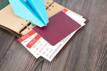 Tickets and passports on the notebook and abstract paper airplanes