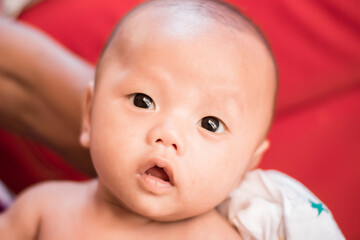 Portrait of new born baby boy resting in mothers arms,family concept,cose up.