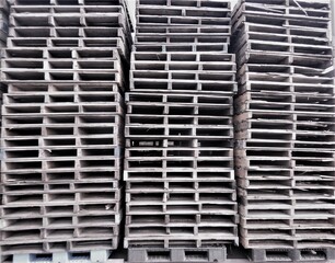 Many stacked forklift pallets