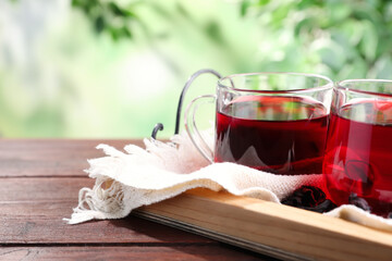 Freshly brewed hibiscus tea on wooden table
