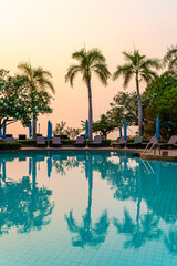 beach chair or pool bed with umbrella around swimming pool