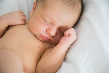 close up. a newborn sleeps in a white crib. concept of healthy children's sleep