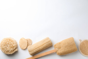 Natural shower loofah sponges on white background, top view