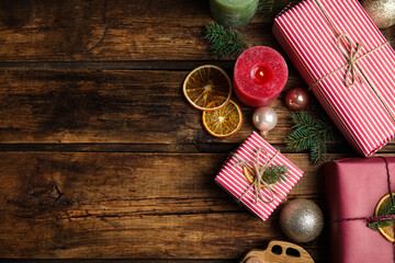 Flat lay composition with beautifully wrapped gift boxes on wooden table, space for text