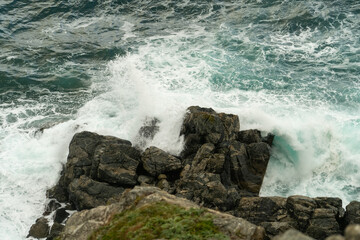 Seascape with waves crashing on rocks