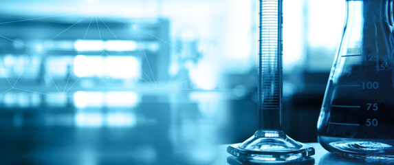 flask and cylinder in medical science lab blue banner background