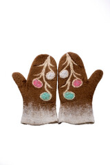 Brown mittens made of felted wool on a white background