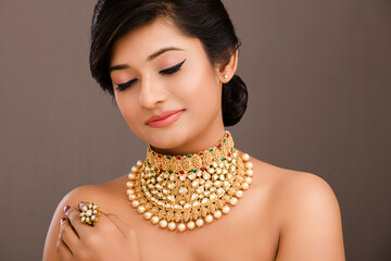 Beautiful Indian young women portrait with Indian traditional jewelry studio shot.