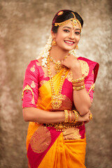 Beautiful smiling Indian bride with jewelry in studio shot. © krishna