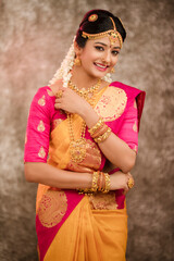 Beautiful smiling Indian bride with jewelry in studio shot. © krishna