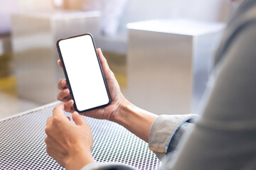 cell phone blank white screen mockup.woman hand holding texting using mobile on desk at office.background empty space for advertise.work people contact marketing business,technology