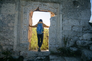 Tourist in the ruins of an ancient fortress, Crimea, Russia.