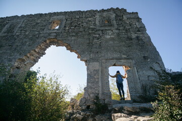 Tourist in the ruins of an ancient fortress, Crimea, Russia.