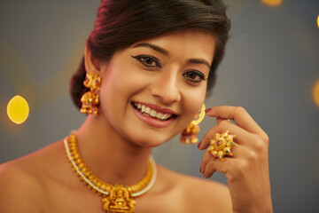 Beautiful Indian young women portrait with Indian traditional jewelry studio shot.