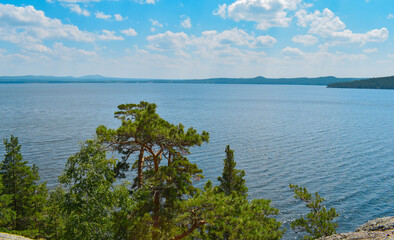 Fototapeta na wymiar A big beautiful lake., mountains, pine trees. The beautiful views of nature. Beautiful blu sky with clouds. Burabay, Kazakhstan.