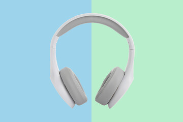 White headphones on colored background.