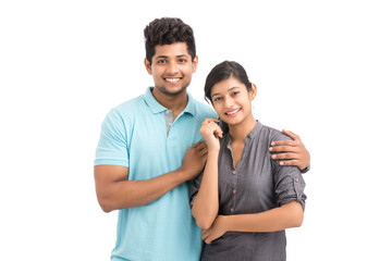 Beautiful happy young couple looking at the camera on white.