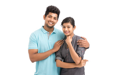 Beautiful happy young couple looking at the camera on white.