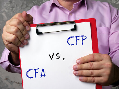 Certified Financial Planner CFP Vs. CFA Chartered Financial Analyst Sign On The Page.