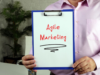 Financial concept about Agile Marketing with inscription on the piece of paper.