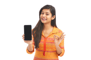 Cheerful Indian attractive women holding smartphone against White.