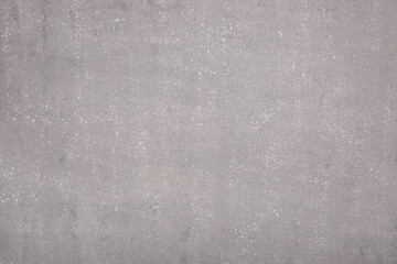 Gray background under concrete, wet asphalt.