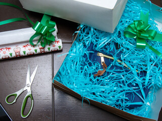 wrapping gift with scissors, tape and paper