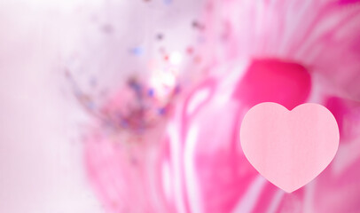 Pink heart on a background of pink balls.Valentine's day