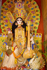 Idol of Goddess Devi Saraswati at a decorated puja pandal in Kolkata, West Bengal, India. Saraswati Puja is a popular religious festival of Hinduism.