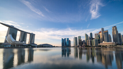 Obraz premium Ultra wide panorama image of Singapore skyscrapers illuminated by morning sunlight early in the morning.