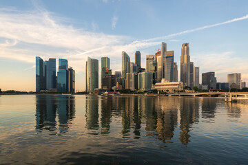 Fototapeta na wymiar Ultra wide panorama image of Singapore skyscrapers illuminated by morning sunlight early in the morning.
