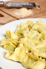 Tortellini stuffed with spinach and ricotta. Covered with grated cheese.