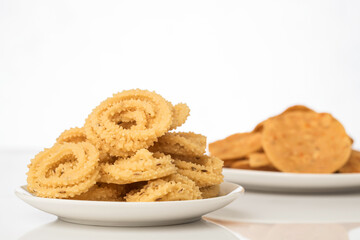 Chakli the savoury indian spicy snack on white.