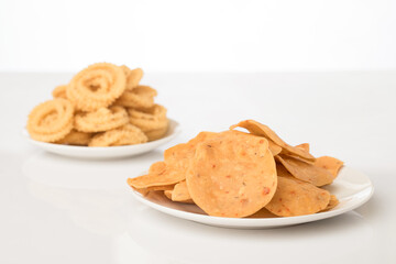 Chakli the savoury indian spicy snack on white.
