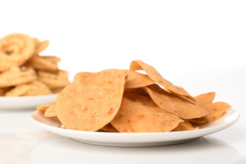 Chakli the savoury indian spicy snack on white.