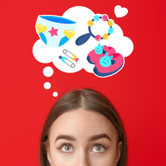 Young woman thinking about pregnancy on color background