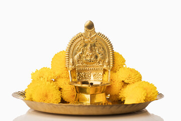 Indian oil lamp with flowers( Kamatchi Vilakku ) on white.