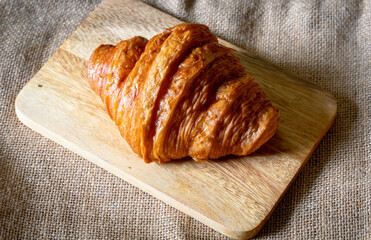 Morning croissant on wood plate