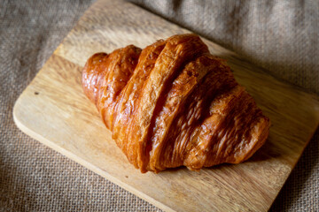 Morning croissant on wood plate