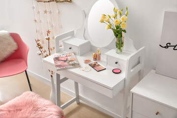 Table with mirror and decorative cosmetics in modern makeup room