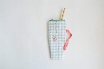Reusable straw zipper pouch over white	