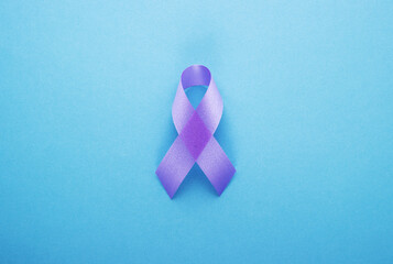 purple ribbon on a blue background. world day of fight against cancer