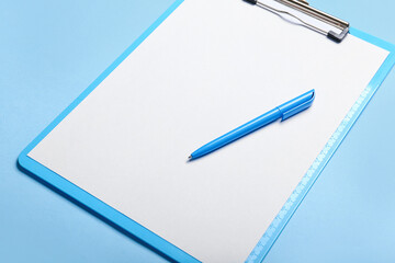 Clipboard with blank paper sheet and pen on color background