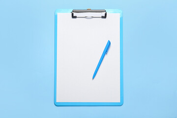 Clipboard with blank paper sheet and pen on color background