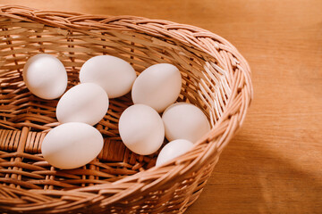 wooden basket with eggs studio shot.