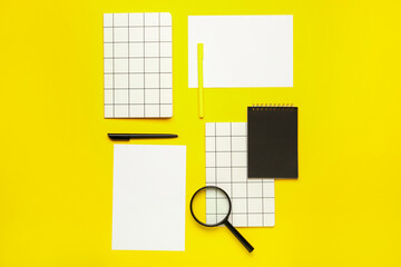 Composition with blank paper sheets and stationary on color background