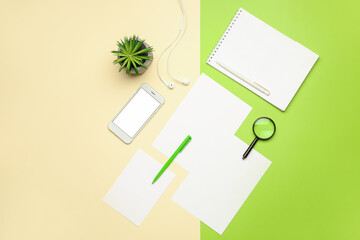 Composition with blank paper sheets, mobile phone and stationary on color background